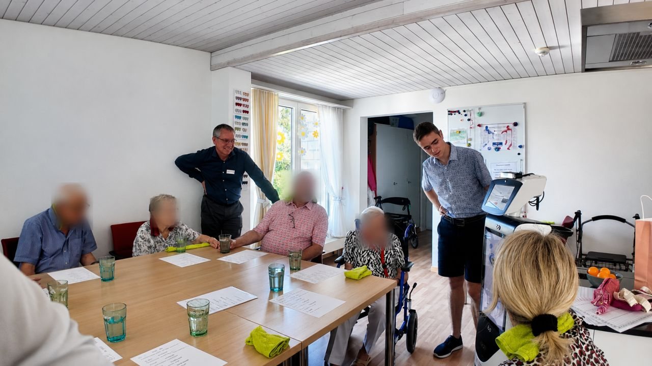 The robot taking part in a group activation session with residents and a carer